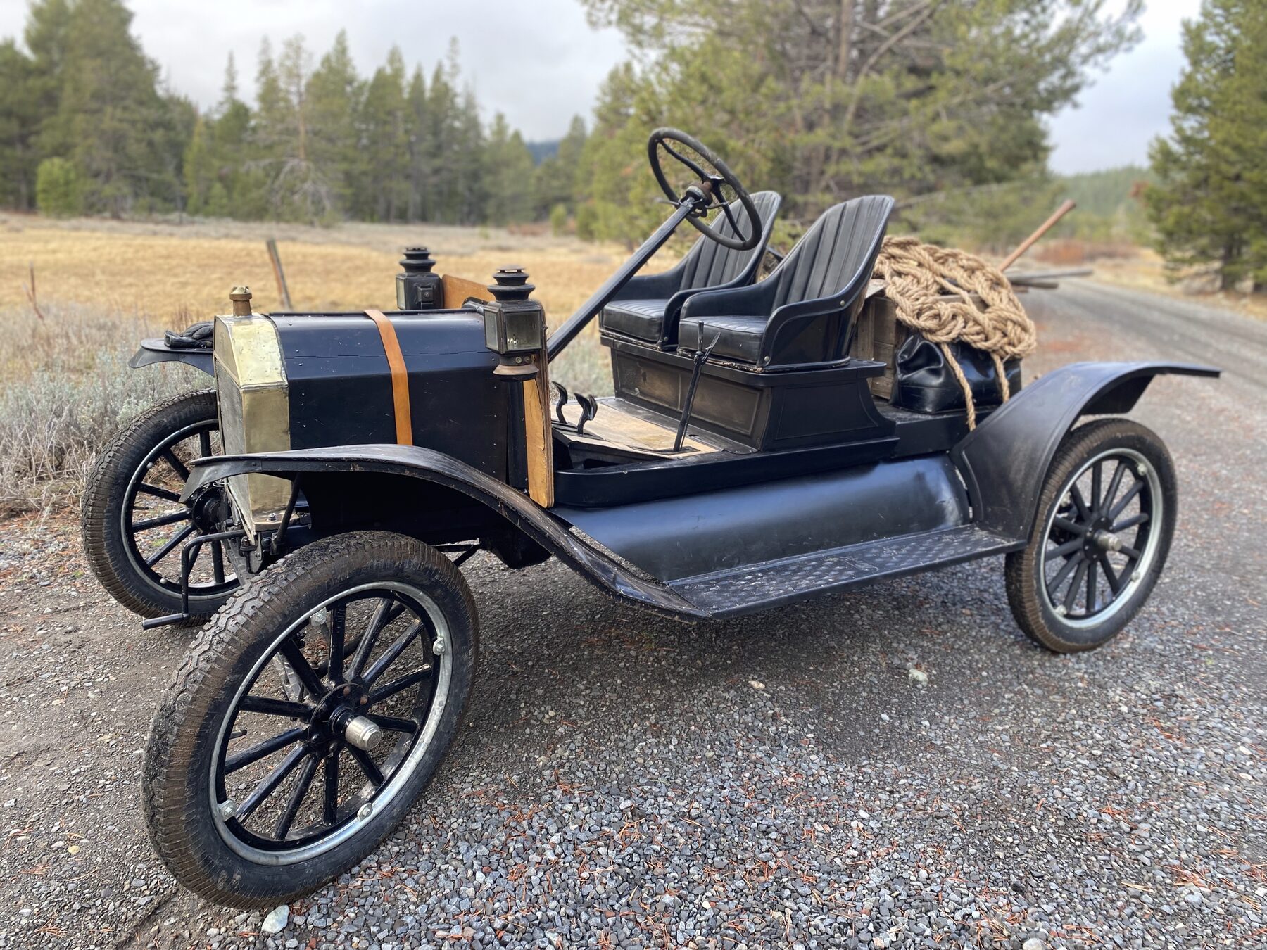 Low front-quarter view of The General T, a 1911 Ford Model T, against Sierra Nevada pines