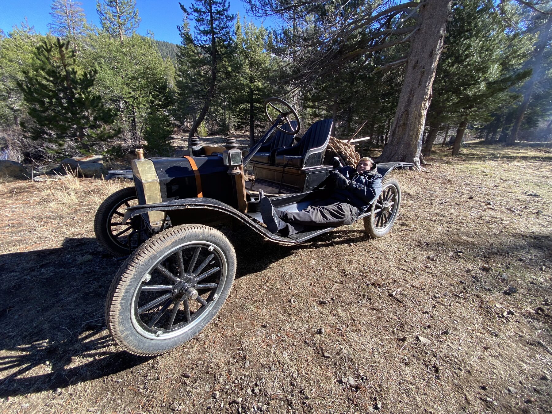 Side profile of The General T, a brass-era 1911 Ford Model T, on a dirt road in the Sierra